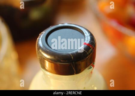 Une photo d'un couvercle noir d'une bouteille de sauce en verre. Banque D'Images
