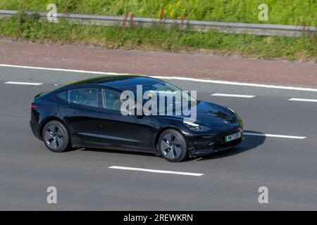 2021 (71) Noir Tesla modèle 3 long Range AWD ; se déplaçant à grande vitesse sur l'autoroute M6 dans le Grand Manchester, Royaume-Uni Banque D'Images