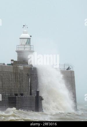 Les vagues s'écrasent au-dessus du bras du port pendant le mauvais temps à Folkestone, Kent. Date de la photo : lundi 31 juillet 2023. Banque D'Images