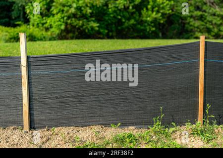 Tissu Silt Fence avec poteaux en bois installés avant le début de la construction. Banque D'Images