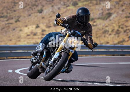 le motocycliste prend une courbe nette sur sa moto. Photographie prise dans le port de Navalmoral, province de la ville d'Avila, Espagne, pendant la journée Septem Banque D'Images