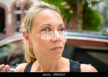 Gros plan extrême du visage d'une jolie femme attrayante dans la ville Banque D'Images