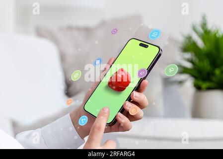 Utiliser un smartphone pour rechercher des aliments sains en ligne. concept. Téléphone dans la main de femme avec poivre sur l'écran, achats en ligne et icônes de la nourriture volant arroun Banque D'Images