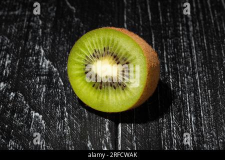 kiwi tranché sur fond de bois Banque D'Images