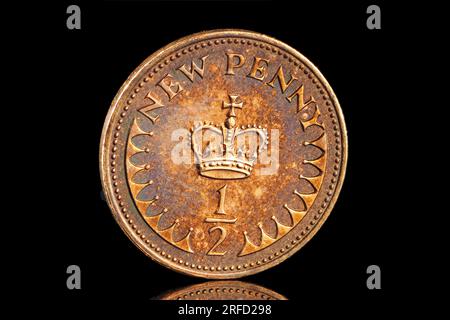 Gros plan de la plus petite pièce du Royaume-Uni, un demi Penny qui a maintenant été démonétisé. Banque D'Images