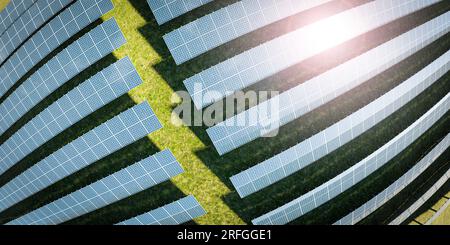 Ferme solaire de panneaux photovoltaïques sur une belle prairie verdoyante avec des éoliennes en arrière-plan Banque D'Images