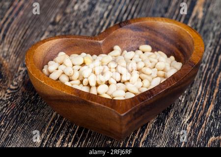 pignons de pin pelés de petite taille, noix utiles, une partie de la coquille reste sur les noix de cèdre Banque D'Images