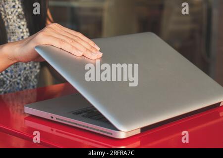 Jeune femme travaillant sur un ordinateur portable, gros plan, bokeh flou Banque D'Images