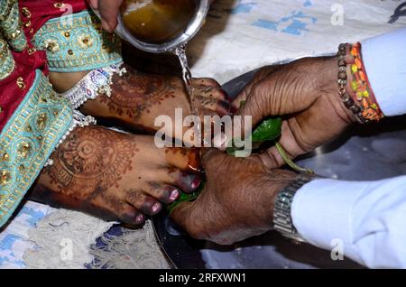 Image d'une mariée hindoue lavant les pieds pendant la cérémonie de mariage traditionnelle Banque D'Images