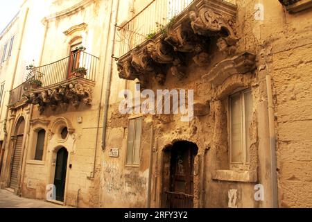 Ancien bâtiment avec des corbeaux magnifiquement sculptés dans le centre historique de Lecce, en Italie Banque D'Images