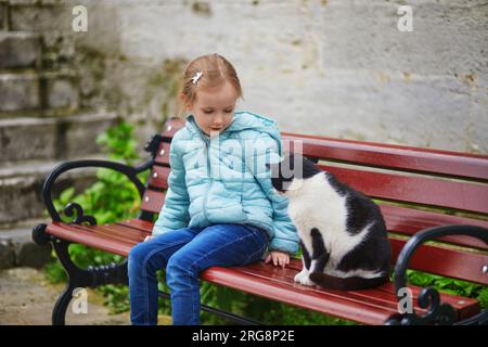 Adorable fille préscolaire caressant un chat dans le quartier Uskudar sur le côté asiatique d'Istanbul, Turquie Banque D'Images