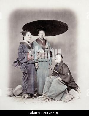 1860's Japon - Portrait de deux jeunes femmes et un jeune homme Felice ou Felix Beato (1832 - 29 janvier 1909), photographe italien-britannique travaillant principalement en Inde, au Japon, en Chine Banque D'Images