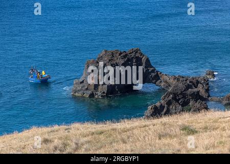 Île de Madère Portugal - 04 19 2023 : vue sur la zone côtière, à la pointe de St. Lourenço, roche avec tunnel d'érosion causé par la mer et bateau avec f Banque D'Images