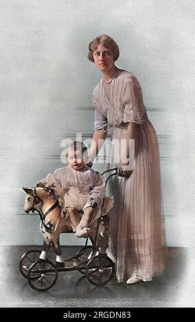 Alexandra, duchesse de Fife (1891-1959) avec son fils unique, Alastair Arthur, comte de Macduff, 2e duc de Connaught (1914-1943). Alexandra était la fille aînée de la princesse Louise de Galles, duchesse de Fife ; après la mort de son père à Assouan en 1912, elle a été autorisée à hériter du duché de Fife à part entière. Elle était généralement connue sous le nom de princesse Arthur de Connaught après son mariage avec son cousin, le prince Arthur de Connaught. Bébé Alastair est assis sur un cheval jouet pousse-a-long plutôt gentil à roues. Banque D'Images