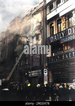 La brigade des pompiers répond à un incendie de bâtiment à côté des bureaux Daily Sketch à Manchester (C. Walter and Co.) Une échelle d'évacuation à roues a été déployée dans la fenêtre supérieure droite où deux personnes peuvent être vues en essayant d'échapper au bâtiment par la fumée. Banque D'Images