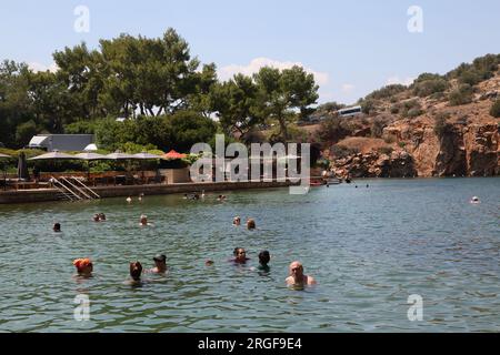 Vouliagmeni Athènes Grèce touristes nager dans le lac Vouliagmeni un Spa naturel - était une fois une caverne, mais le toit de la grotte est tombé en raison de l'érosion de la Banque D'Images