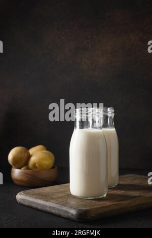 Lait de pomme de terre végétalien en bouteilles, substitut de lait à base de plantes. Banque D'Images