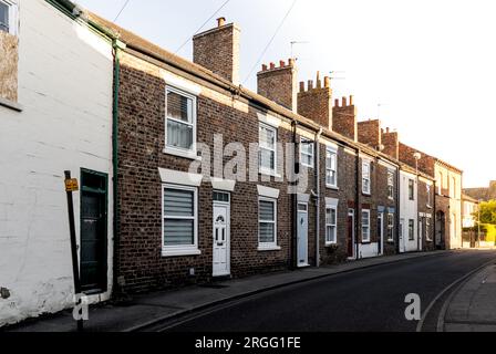 Une rangée de maisons mitoyennes délabrées sur une rue de la ville dans le nord de l'Angleterre pendant le processus de nivellement avec la lumière du soleil à la fin du stre Banque D'Images