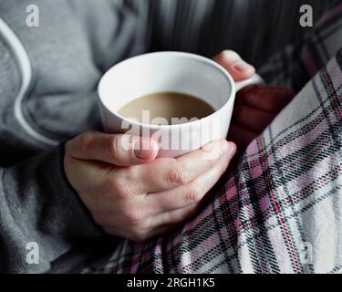 Woman's hand holding cup of tea Banque D'Images