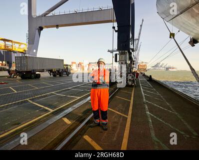 Docker en combinaison orange sur le port de Felixstowe, England Banque D'Images