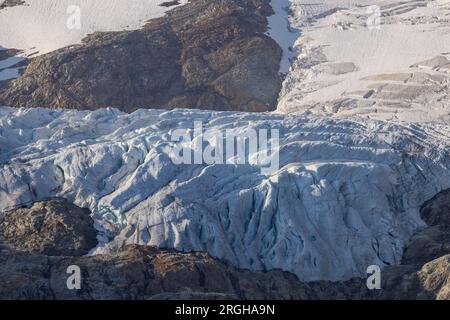 Vue panoramique sur le grand glacier Titlis en Suisse avec ciel bleu, nuages blancs, montagnes enneigées. Banque D'Images