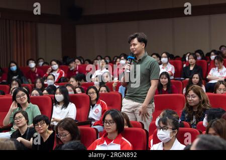 Reportage : visite d'une délégation de l'USDA avec le secrétaire Tom Vilsack au Vietnam (avril 2023) - Un étudiant de l'Université du commerce extérieur de hanoi pose une question au secrétaire Vilsack lors d'une séance de questions-réponses Banque D'Images