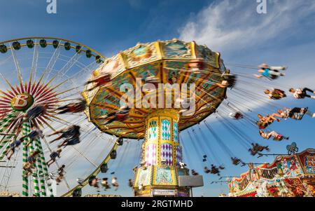 Herne, Allemagne. 11 août 2023. Un manège traditionnel de manège de swing s'avère populaire. Les gens sur une promenade à sensations fortes. La fête foraine sur sa journée la plus chargée jusqu'à présent, sous un beau soleil et des températures chaudes attirant la foule. La foire de Cranger kirmes est l'une des plus grandes d'Allemagne. La foire populaire attire régulièrement plus de 4 millions de visiteurs au cours de ses 10 jours de course, la grande majorité d'entre eux ayant assisté au dernier week-end. La foire remonte au début du 18e siècle à Crange. Crédit : Imageplotter/Alamy Live News Banque D'Images