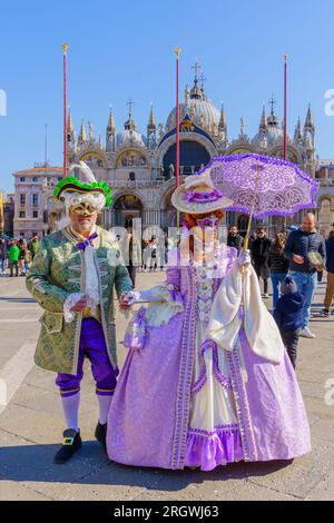 Venise, Italie - 28 février 2022 : couple vêtu de costumes traditionnels, sur la place Saint-Marc, partie du carnaval du masque de Venise, Vénétie, Italie Banque D'Images