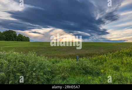 Nuages de tempête passant au-dessus d'un champ de foin dans le nord du Wisconsin. Banque D'Images