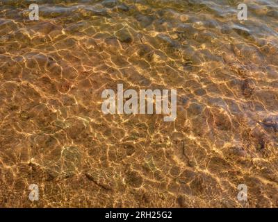Grâce à l'eau claire, vous pouvez voir le fond du lac, l'éblouissement du soleil sur l'eau. Banque D'Images
