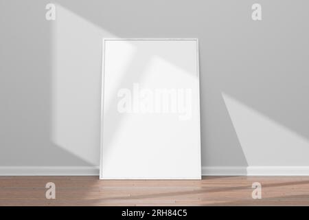 Modèle de conception pour la mise en page. Cadre blanc en bois blanc réaliste sur un mur blanc et plancher en bois. Rendu 3D. Banque D'Images