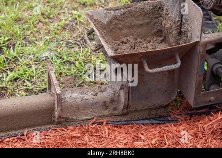 Verser du béton pour une bordure de jardin Banque D'Images