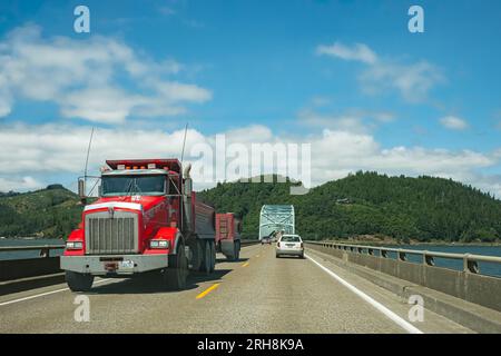 Camion rouge semi-camion avec remorque conduisant sur l'autoroute. Gros camion de manutention transportant des marchandises circulant sur l'autoroute. Entreprise, commercial, transpor de fret Banque D'Images