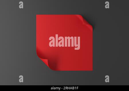 Un morceau de papier rouge avec des bords incurvés sur fond gris Banque D'Images