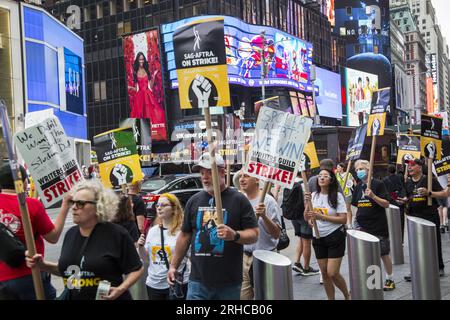 New York City : la grève se poursuit parmi les Writers Guild of America et les membres du syndicat SAG-AFTRA avec des lignes de piquetage dans plusieurs endroits de Manhattan. Les membres du syndicat manifestent le long de Broadway à Times Square, paralysant l'industrie du divertissement. Banque D'Images