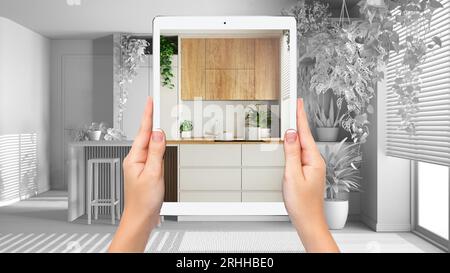 Mains tenant tablette montrant cuisine minimale, fond de projet vide total, concept de réalité augmentée, application pour simuler des meubles et interio Banque D'Images