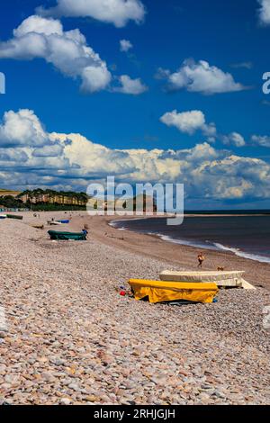 Bateaux colorés sur la plage de Budleigh Salterton regardant vers l'est vers l'embouchure de la rivière Otter et Otterton Ledge promontoire , Devon, Angleterre, Royaume-Uni Banque D'Images