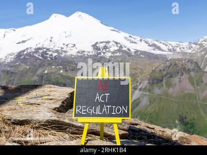 Symbole de régulation de l'acte ai. Mots conceptuels IA intelligence artificielle agissent la régulation sur un beau tableau noir de craie. Beau fond de montagne Elbrus. Banque D'Images