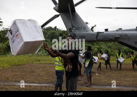 Île de Bougainville, Papouasie-Nouvelle-Guinée. 13 août 2023. Les villageois et les travailleurs de l'Agence de secours déchargent l'aide humanitaire d'un hélicoptère CH-53E Super Stallion de la Marine américaine après les éruptions du volcan Bagana, le 13 août 2023, sur l'île de Bougainville, Papouasie-Nouvelle-Guinée. Crédit : Lcpl. Bridgette Rodriguez/États-Unis Marines/Alamy Live News Banque D'Images