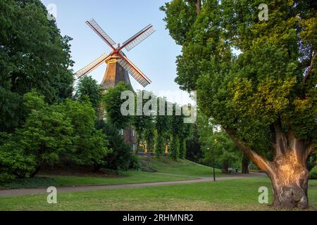 Moulin à vent dans Wallanlagen Park dans la ville de Bremen Allemagne. Moulin à vent dans le parc d'été. Moulin à vent dans le jardin de la ville dans la lumière du matin. Moulin avec arbres. Banque D'Images