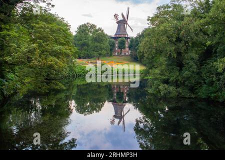 AM Wall Windmill dans le parc d'été avec étang. Moulin à vent avec réflexion dans l'eau dans le jardin de la ville. Architecture historique à Brême. Point de repère allemand rural. Banque D'Images