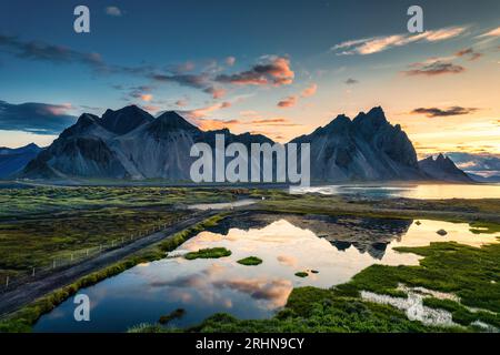 Lever de soleil majestueux sur la montagne Vestrahorn avec nature sauvage et reflet du lac en été sur la péninsule de Stokksnes, au sud-est de l'Islande Banque D'Images
