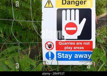 Les panneaux de danger à l'extérieur de Holme Park Quarry sur Holme Park tombaient au-dessus de Burton-in-Kendal Cumbria Banque D'Images