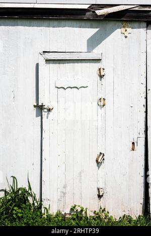 Vieille porte de grange en bois rustique blanc en plein soleil Banque D'Images