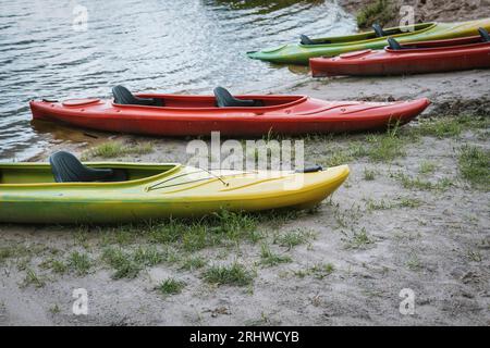 Plusieurs kayaks colorés vides sur la plage. Banque D'Images