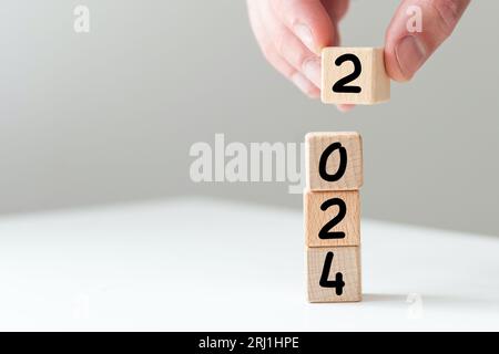 De 2023 à 2024. Joyeux Noël et bonne année, fond blanc.2024 concept d'idée de nouvelle année. Banque D'Images