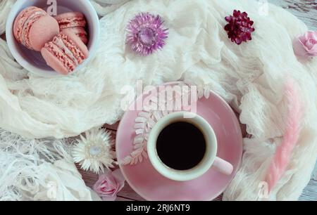 Plat rose & blanc avec café, macarons et fleurs séchées Banque D'Images