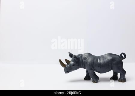 un rhinocéros jouet en plastique sur un fond blanc Banque D'Images