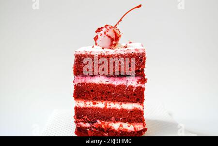 Cake Red velvet with whipped cream and white chocolate covered cherry Stock Photo