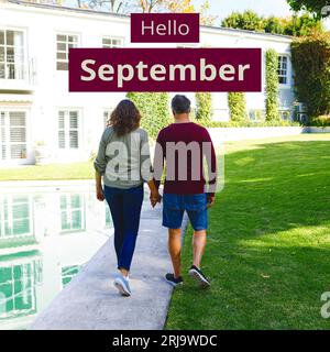 Composite de texte bonjour septembre sur couple caucasien dans le jardin Banque D'Images